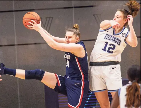  ?? Laurence Kesterson / Associated Press ?? UConn guard Anna Makurat (24) grabs a rebound away from Villanova forward Lior Garzon (12) during Tuesday’s game in Villanova, Pa. Makurat led the Huskies with nine rebounds.