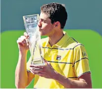  ??  ?? Sealed with a kiss: John Isner celebrates his Miami Open victory at Key Biscayne