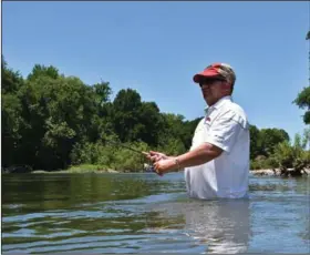  ?? (Arkansas Democrat-Gazette/Bryan Hendricks) ?? Greg Ellis fishes waist-deep in the cool waters of the Caddo River last week. Despite rain earlier in the week, conditions were perfect for a memorable outing of smallmouth bass fishing.