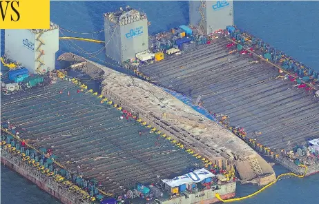  ?? AFP/GETTY IMAGES ?? The damaged Sewol ferry is shown between two barges after being raised during a salvage operation off the South Korean coast on Thursday. It’s been nearly three years since the Sewol went down with the loss of more than 300 lives, mostly students on a...