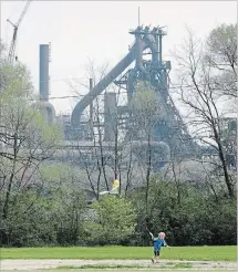  ?? AP FILE PHOTO ?? A child flies a kite near AK Steel's Middletown Works plant in Middletown, Ohio. Author J.D. Vance's book Hillbilly Elegy: A Memoir of a Family and Culture in Crisis provides a vivid tour of the stark world he grew up in,.