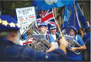  ?? (Henry Nicholls/Reuters) ?? AN ANTI-BREXIT marching band performs in London yesterday.