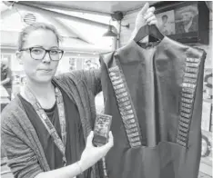  ?? EDWARD C. BAIG, USA TODAY ?? At SXSW, Pauline van Dongen of Wearable Solar shows off a solar dress she designed that can charge a smatphone.