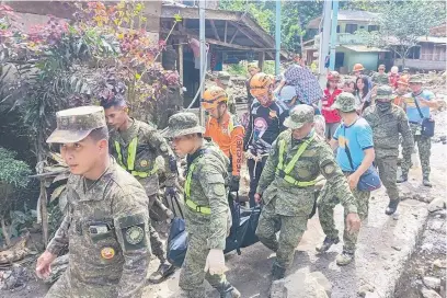  ?? Picture: AFP ?? SEARCHING. Armed Forces of the Philippine­s conduct search-and-rescue operations in Maco, Davao de Oro, where a rain-induced landslide buried vehicles and people.
