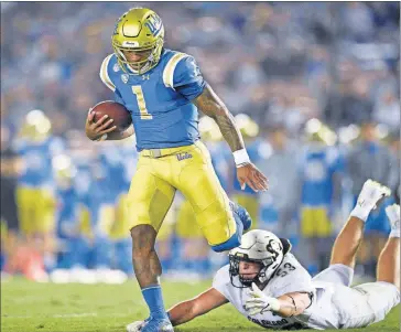  ?? [KELVIN KUO/ASSOCIATED PRESS FILE PHOTO] ?? UCLA quarterbac­k Dorian Thompson-Robinson evades a tackle by Colorado linebacker Nate Landman during a Nov. 2 game in Los Angeles.
