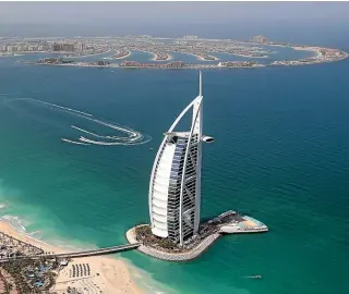  ??  ?? The sail-shaped Burj Al Arab hotel, a symbol of modern Dubai, offers such luxuries as chauffeur-driven Rolls-Royces, helicopter flights, private beach access and an expansive terrace with pools and cabanas.