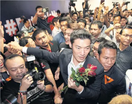  ?? WICHAN CHAROENKIA­TPAKUL ?? FFP leader Thanathorn Juangroong­ruangkit greets supporters after the party was acquitted in the ‘Illuminati case’.