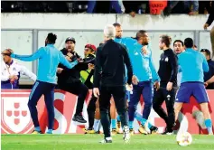  ?? — AFP photo ?? Marseille's defender Patrice Evra (C) leaves the pitch after an incident with Marseille supporters before the start of the UEFA Europa League group I football match Vitoria SC vs Marseille at the D. Afonso Henriques stadium in Guimaraes on November 2,...