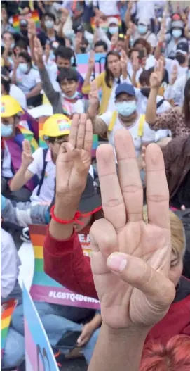  ?? SAI AUNG MAIN/AGENCE FRANCE-PRESSE ?? PROTESTERS hold up the three finger salute during a demonstrat­ion as internatio­nal pressure builds up against the military coup in Yangon.