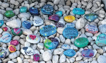  ?? AL DIAZ • AP ?? Stones are placed at a memorial outside Marjory Stoneman Douglas High School during the one-year anniversar­y of the school shooting, on Thursday in Parkland, Fla. A year ago on Thursday, 14 students and three staff members were killed when a gunman opened fire at the high school.