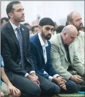  ??  ?? Hamid Hayat prays during Eid ul-Adha celebratio­ns. Basim Elkarra, director of the Sacramento chapter of the Council on American-Islamic Relations, is on the left.