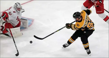  ?? STUART CAHILL / HERALD STAFF ?? BREAKING THROUGH: Brad Marchand scores on Hurricanes goaltender Pyotr Kochetkov during Game 3 on Friday night.