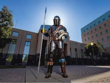  ?? MARK RIGHTMIRE/ORANGE COUNTY REGISTER ?? Yuri Williams, wearing his Mandaloria­n costume, is a deputy juvenile correction­al officer in Orange County, California. Williams dresses in superhero costumes when visiting sick children and homeless adults.