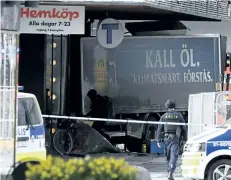  ?? JONATHAN NACKSTRAND/GETTY IMAGES ?? Police cordon off the truck which crashed into the Ahlens department store in central Stockholm, Sweden, on Friday.