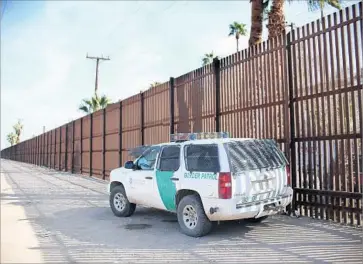  ?? Sandy Huffaker AFP/Getty Images ?? A BORDER FENCE already stands near Calexico, Calif. Albert Garcia, who spent more than two decades fixing holes in the fence, said there are better ways to strengthen the border than building a new wall.