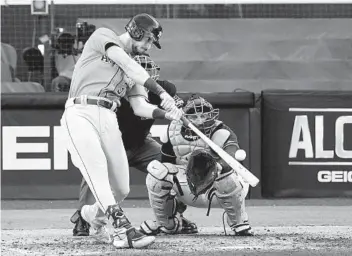  ?? JAE C. HONG AP ?? Houston’s Kyle Tucker hits a solo home run in the sixth inning of Friday’s Game 6 victory over Tampa Bay.