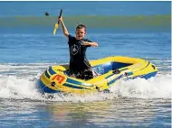  ?? MURRAY WILSON/STUFF ?? A beach-goers gets his feet wet at Himatangi Beach – without the worry of shark attacks.