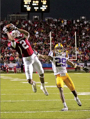  ?? Arkansas Democrat-Gazette/BENJAMIN KRAIN ?? (2) catches the game-winning pass from quarterbac­k Casey Dick behind LSU’s Chris Hawkins (29), giving the Razorbacks a 31-30 victory over LSU in a game dubbed “Miracle on Markham II” in November 2008.