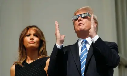  ??  ?? Donald Trump and Melania watch the solar eclipse from the White House in August 2017. Photograph: Kevin Lamarque/Reuters