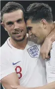  ??  ?? Jordan Henderson and John Stones enjoy Friday’s win.