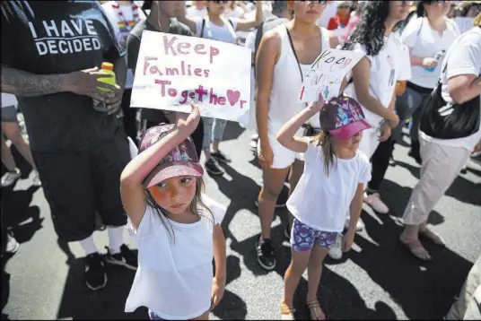  ?? Erik Verduzco Las Vegas Review-Journal @Erik_Verduzco ?? Estella Perkins, left, 7, and twin sister Sophia attend a rally Saturday outside the Lloyd George U.S. Courthouse to protest the separation of immigrant families.