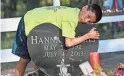  ?? RION SANDERS/USA TODAY NETWORK ?? Jeremiah Harris, 9, rests on his mother’s headstone at his family cemetery plot in Lame Deer, Montana.