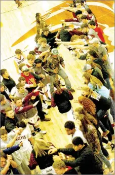  ?? MARK HUMPHREY ENTERPRISE-LEADER ?? Lincoln varsity girls basketball players come out onto the court greeted by enthusiast­ic fans in the spirit line.