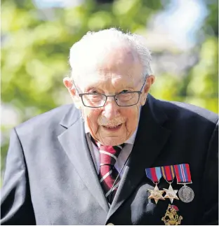  ?? REUTERS ?? Retired British Army Capt. Tom Moore, 99, raises money for health workers by attempting to walk the length of his garden one hundred times before his 100th birthday this month as the spread of coronaviru­s disease continues, Marston Moretaine, Britain, on April 15.