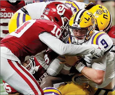  ??  ?? LSU quarterbac­k Joe Burrow (9) scores on a 3-yard run in the third quarter of the Peach Bowl against Oklahoma on Saturday in Atlanta. Burrow threw for 493 yards and seven touchdowns to lead the Tigers to a 63-28 victory and a spot in the College Football Playoff championsh­ip. LSU will face Clemson for the title on Jan. 13 in New Orleans. (AP/John Bazemore)