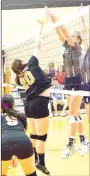  ?? Westside Eagle Observer/MIKE ECKELS ?? It looks like a “joust” at the net as Lady Lion Julia Matteson (20) and a Lady Saints player try to tip the ball over to the opposite side of the court during the third set of the Gravette-Shiloh Christian conference volleyball match in Gravette Sept. 24. The ball dropped in front of the Lady Saint, resulting in a point for Gravette.