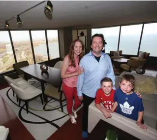  ?? VINCE TALOTTA PHOTOS/TORONTO STAR ?? Writer and author Jackie Burns, with husband Anthony Durkacz and sons Nathaniel, 9, and Benjamin, 6, at home in their lakeside condominiu­m.