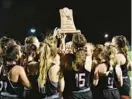  ?? BARBARA HADDOCK TAYLOR/ BALTIMORE SUN ?? Crofton field hockey players hoist the championsh­ip trophy after winning the Class 3A title over River Hill at Stevenson University’s Mustang Stadium on Saturday night.