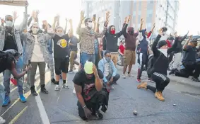  ??  ?? Demonstrat­ors gather in the street Friday in Minneapoli­s as protests continued after the death of George Floyd in police custody.