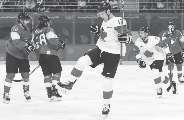  ?? NATHAN DENETTE/THE CANADIAN PRESS ?? Lac La Biche, Alta., native Rene Bourque, centre, celebrates one of his two goals in Canada’s 5-1 victory over Switzerlan­d.