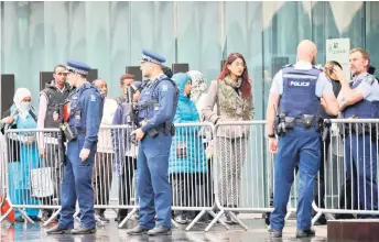  ??  ?? Survivors and family members of victims of the Christchur­ch mosque attacks arrive outside the Christchur­ch High Court ahead of the first day of the four-day hearing.