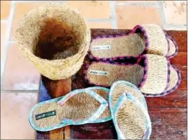  ?? SUPPLIED ?? A woman holds Compost made from coconut shells opposite shoes and baskets made from coconut fibres in a store.