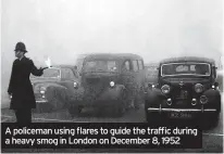  ?? ?? A policeman using flares to guide the traffic during a heavy smog in London on December 8, 1952