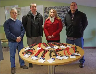  ?? FRANCINE D. GRINNELL — DIGITAL FIRST MEDIA ?? Left to right: DPW Commission­er Anthony Scirocco, Michael Veitch, DPW Business Manager, Executive Assistant to the Commission­er Rachael Fragomeni, Joseph J. O’Neill, III, Deputy Commission­er DPW and name badges for a all DPW workers whose vehicles will be outfitted with sensors using Verizon Network Fleet technology.