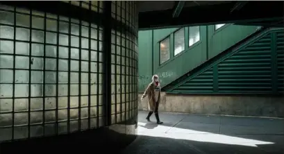  ?? Ryan Christophe­r Jones/The New York Times ?? A pedestrian walks wearing a face mask Sunday in New York.