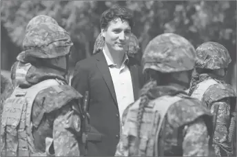  ?? CP PHOTO ?? Prime Minister Justin Trudeau reviews an honour guard as they arrive at the Internatio­nal Peacekeepi­ng and Security Centre in Yavoriv, Ukraine.