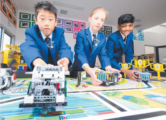  ?? Picture: Mark Wilson ?? Geelong Lutheran college students Ilan, Magdalene and Jayden learn robotics outside regular school hours.