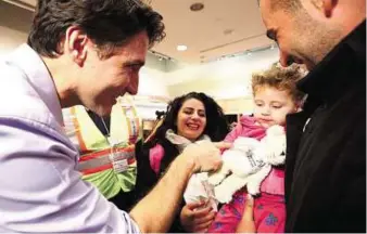  ?? Reuters ?? Trudeau greets first Syrian refugees Canada’s Prime Minister Justin Trudeau greets Syrian refugees at Toronto Pearson Internatio­nal Airport yesterday. Canada welcomed 163 refugees, taking in the first of a planned 25,000 in a matter of months and...