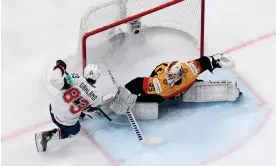  ?? Photograph: Jonathan Nackstrand/AFP/Getty ?? USA's Conor Garland tries to score past Germany's Mathias Niederberg­er during Saturday’s world semi-final at Tampere, Finland.