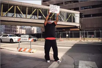  ?? Stephen Maturen / Getty Images ?? Joe Nixon demonstrat­es outside the Hennepin County Government Center on Tuesday in Minneapoli­s. Jury selection is continuing in the trial of former Minneapoli­s Police officer Derek Chauvin, who is charged in the death of George Floyd last May.