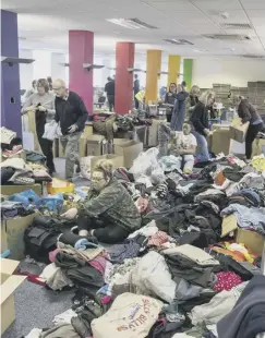  ?? ?? AID: Volunteers sort through donations at Dean Clough in Halifax.