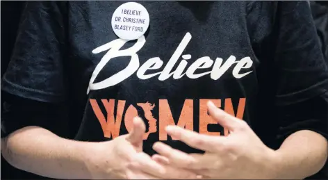  ?? AP PHOTO ?? A woman wears a shirt that reads “Believe Women” with a button that reads “I Believe Dr. Christine Blasey Ford” as protesters against Supreme Court nominee Brett Kavanaugh tell their personal stories of sexual assault outside offices of Sen. Jeff Flake, R-Ariz., on Capitol Hill in Washington Monday.