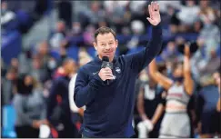  ?? Jessica Hill / Associated Press ?? New UConn football coach Jim Mora is introduced at a women’s basketball game against Arkansas on Nov. 14.