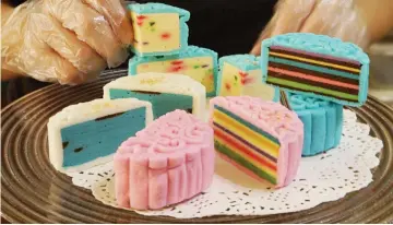  ??  ?? Mooncake with Sarawak’s famous layered-cake (kek lapis) fillings produced by Maria for the Mid-Autumn Festival. — Bernama photo