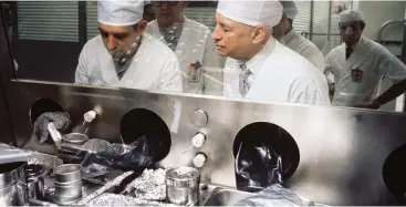  ??  ?? Left: Wearing special germfree clothing, Dr Robert Gilruth (right) inspects lunar samples from the Apollo 17 mission