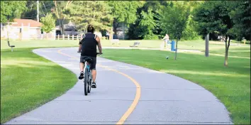  ?? JOE PUCHEK/POST-TRIBUNE ?? New signs, including mileage markers, street signs and welcome signs for the communitie­s they enter, will be placed along the Erie Lakawanna and Prairie Duneland trails this summer. An official said the sign program is paid mostly with federal money.